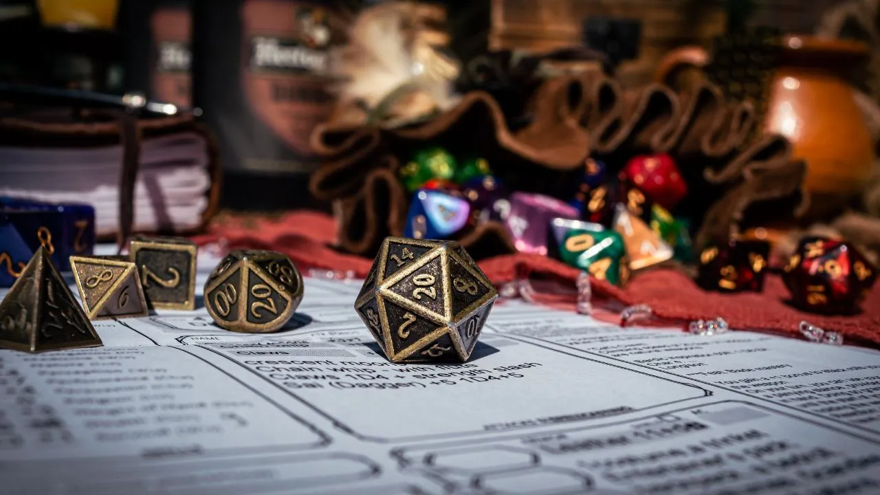 A set of polyhedral dice, including a 20-sided die, rests on a character sheet. Colorful dice and game items are blurred in the background, suggesting a tabletop role-playing game setting.