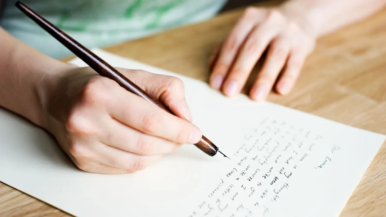 A person writing a letter